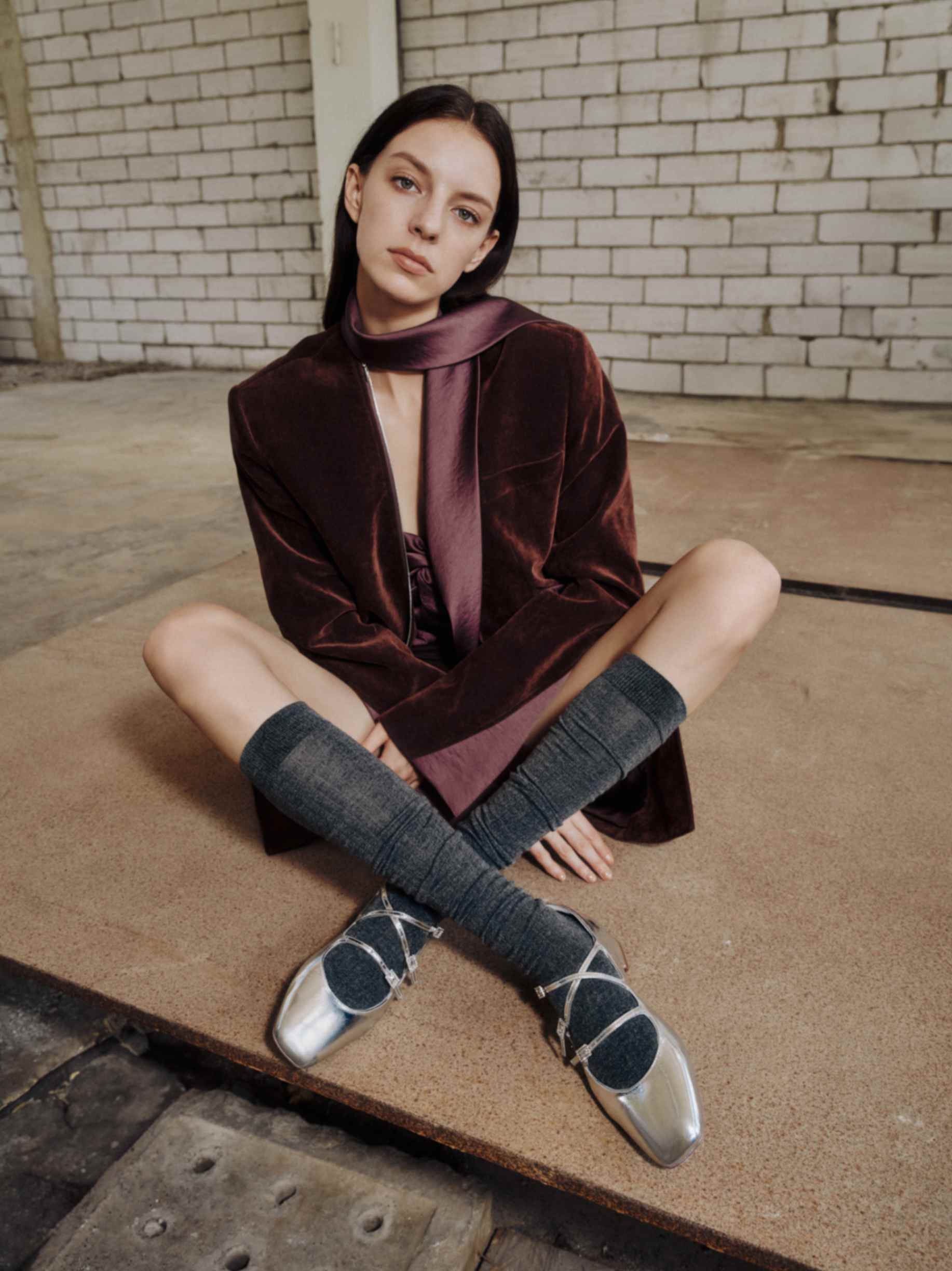 Model styling multi-strap Mary Jane shoes with grey socks